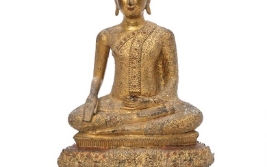 A Thai 19th century gilt bronze buddha seated on a tierced base...