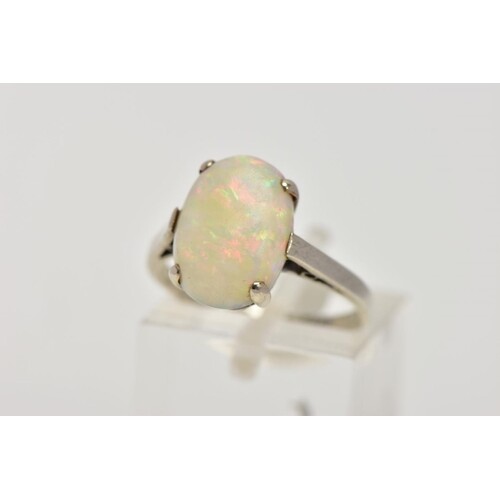 A WHITE METAL OPAL RING, designed with a four-claw set, oval...