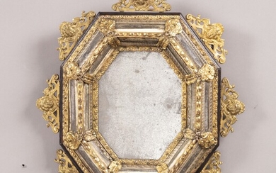 A brass mounted, glass and ebonised wood mirror, Italian, late 17th century Miroir à parecloses, en bois noirci, verre filé et laiton, Italien, fin du XVIIeme siècle