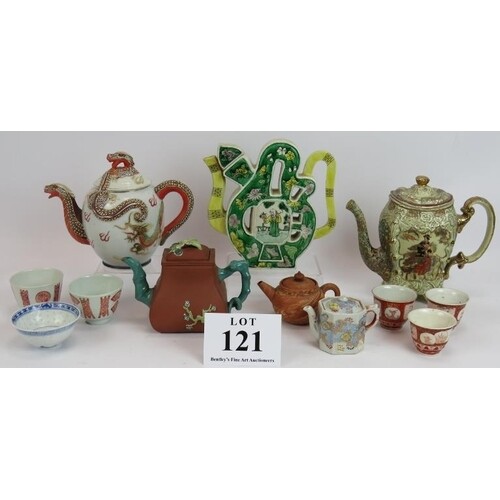A collection of Japanese and Chinese porcelain tea pots and ...