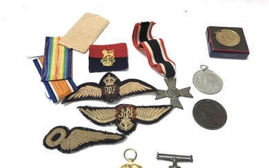 A collection of medals and badges including two world war 1 ...