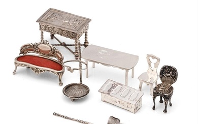 A collection of miniature silver furniture to include a gran...