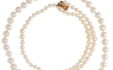 A cultured pearl bracelet and a fresh water cultured pearl necklace, the bracelet composed of three graduated rows of cultured pearls to a 9ct gold garnet circular cluster clasp, length, 18cm; and a uniform single row freshwater cultured pearl...