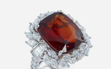 A garnet, diamond, and eighteen karat white gold ring