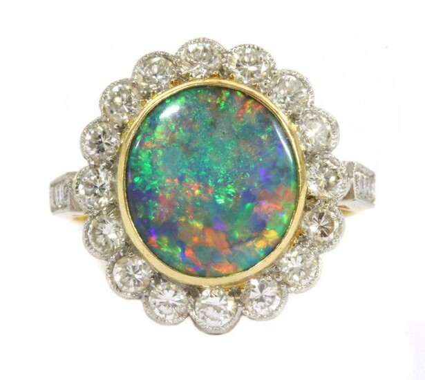 A gold boulder opal and diamond cluster ring, an oval...