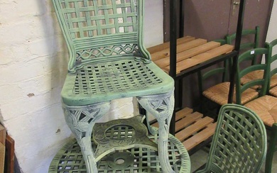 A green PVC garden circular table with a pair of...