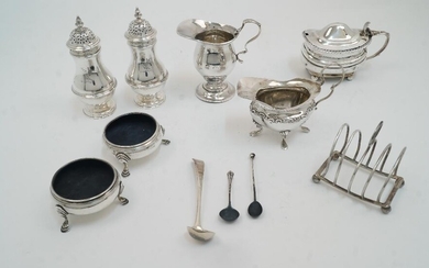 A group of silver comprising: two cream jugs, (one with circular foot, Birmingham, 1920, S W Smith & Co, 8.9cm high and another on four shell capped feet, Birmingham, 1901; 11cm wide); a pair of Victorian baluster peppers, London 1899, Charles...