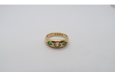 A hallmarked 18ct yellow gold diamond and emerald gypsy ring...