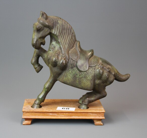 A heavy patinated Chinese bronze figure of a horse on a carved wooden base, overall H. 24cm.