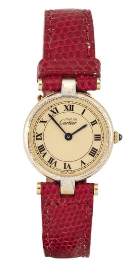 WITHDRAWN A lady's silver gilt quartz wristwatch, by Cartier, the champagne dial with Roman black numerals, blued hands signed Must de Cartier, with cabochon sapphire crown, the strap on case-back also signed Cartier, numbered 189 120489, case...