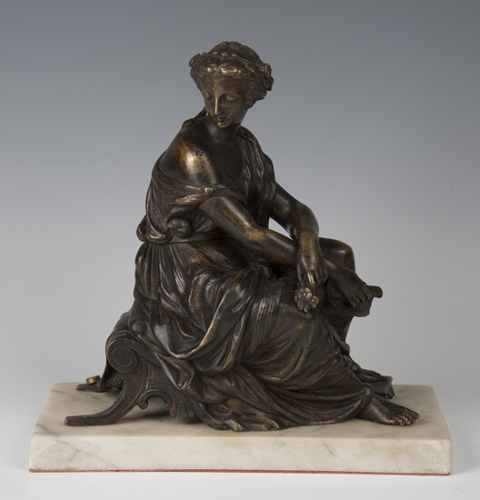 A late 19th century French brown and gilt patinated cast bronze figure of a seated Classical maiden