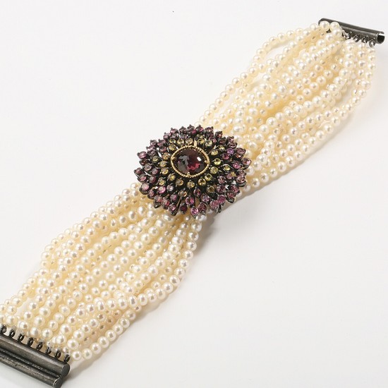 A multi-strand tourmaline and pearl bracelet with cultured freshwater pearls and clasp set with oval and round-cut tourmalines and sapphires mounted in silver