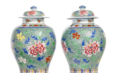 A pair of Chinese famille rose and wucai baluster jars and covers...