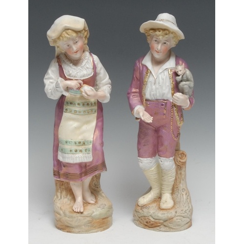 A pair of Continental bisque figures, of a boy with a monke...