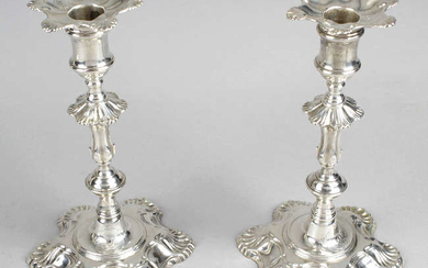 A pair of George II cast silver candlesticks by John Cafe.