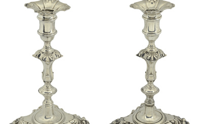 A pair of George II silver cast candlesticks, with knopped stems, on...