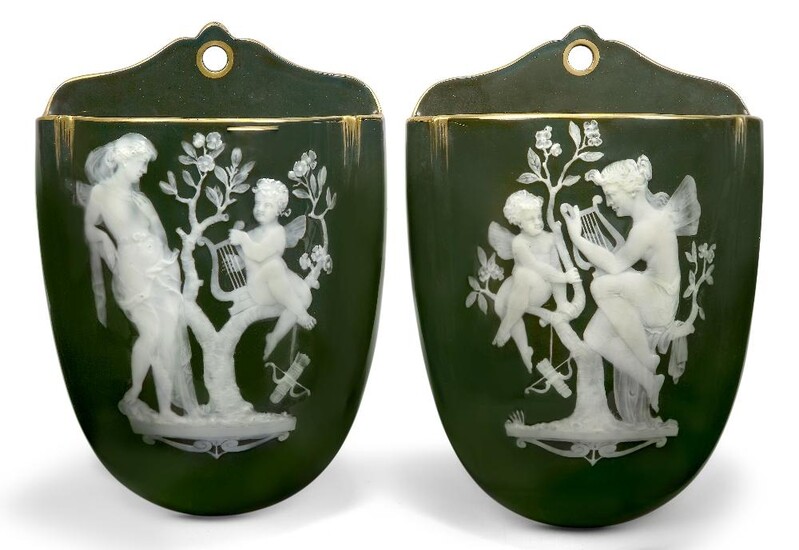 A pair of George Jones olive-brown porcelain pate-sur-pate wall pockets, c.1885, 5653 in gilding to the reverse, attributed to Frederick Schenk, each finely painted and hand-tooled in white slip with a winged nymph and Cupid perched in a tree...