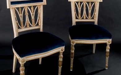 A pair of white lacquered and gilt wood chairs