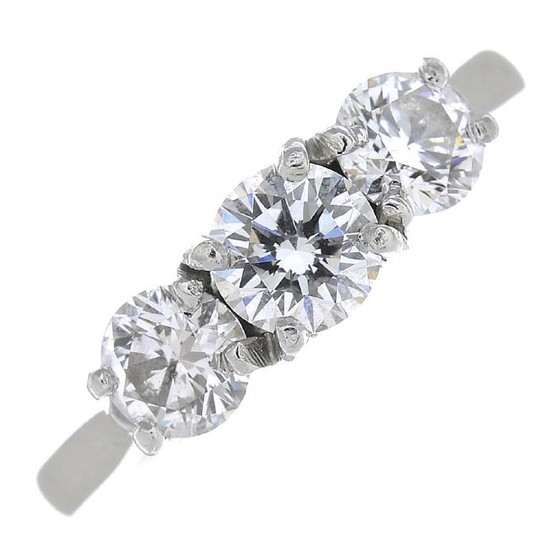 A platinum diamond three-stone ring. The brilliant-cut