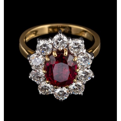 A ruby and diamond ring,: the central oval cut ruby, estimat...