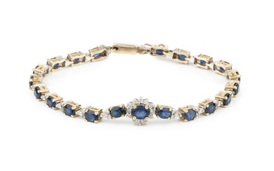 A sapphire and diamond bracelet, the oval cut sapphire set...