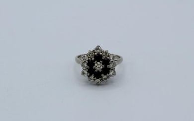 A sapphire and diamond cluster ring in white precious metal....