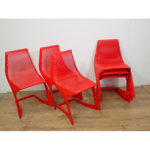 A set of Myto red plastic Chairs with pierced design