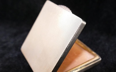 A square silver powder compact, with engine turned decoratio...
