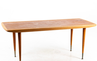 A teak coffee table with brass details in the end of the legs, 1960s.