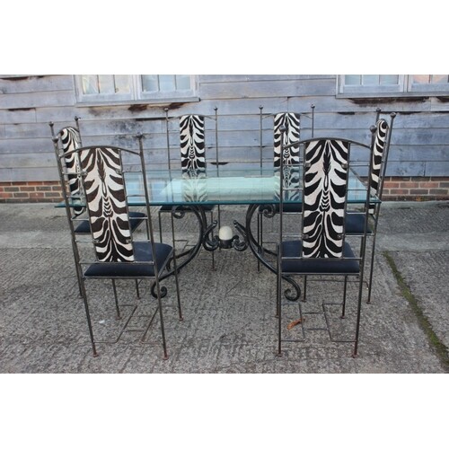 A wrought iron and glass top dining table, 72" wide x 40" de...