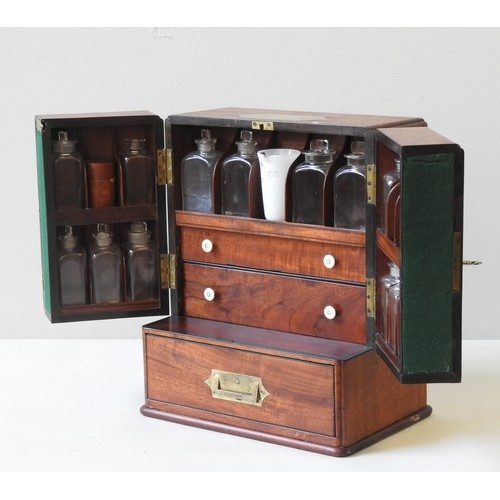 AN EARLY 19TH CENTURY MAHOGANY APOTHECARY CABINET, compact r...