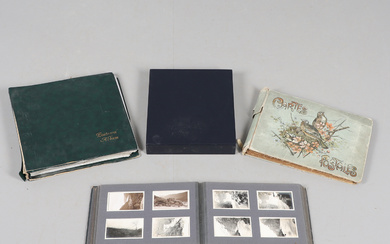 AN EARLY 20TH CENTURY PHOTOGRAPH ALBUM, SIMILAR STAMPS AND POSTCARDS.