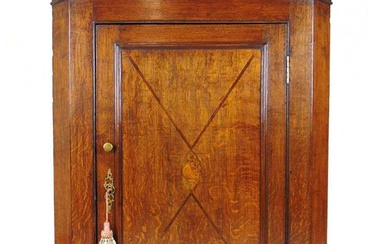 An 18th century oak and inlaid wall hanging corner cupboard,...