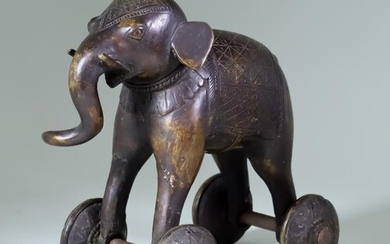 An Indian Bronze Temple Toy Elephant, on wheels 8ins...