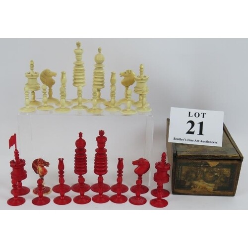 An antique turned ivory chess set with red and white pieces....