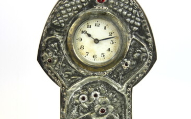 An early 20th Century Arts and Crafts hammered pewter decorated clock, H. 25cm.