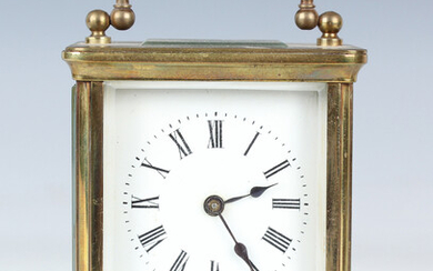 An early 20th brass cased carriage timepiece, the enamelled dial with black Roman hour numerals, the