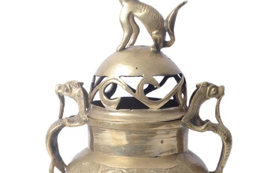 An early 20th century Chinese brass censer / incense burner, with Dog of Fo finial mounted on lid, which features cut out floral decoration, body of burner of squat form with dragon handles and engraved decoration to each side, mounted upon three feet...