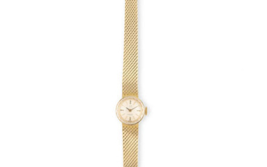Description A LADY'S GOLD WRISTWATCH BY OMEGA, silver dial...