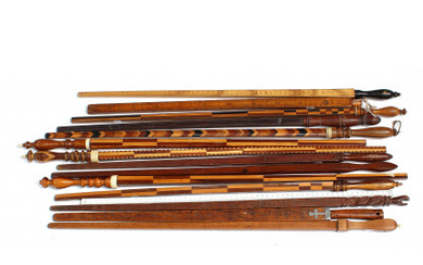 Fifteen wooden tailor's measuring sticks, one of witch of plexiglass