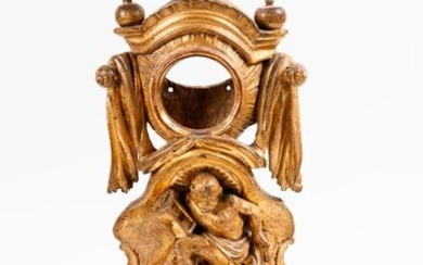 Gilded wooden watch case with high relief decoration of a seated figure
