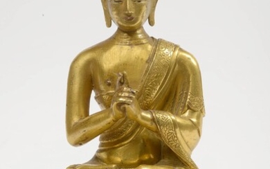 Gilt bronze and partially polychromed "Buddha sitting on a lotus flower". Sino-Tibetan work. Period: 18th century. H.: +/-15,5cm.