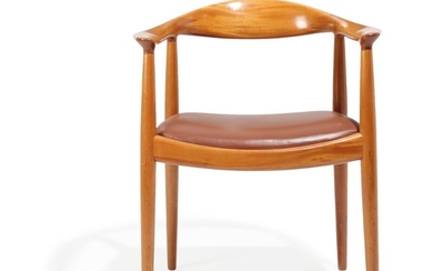 Hans J. Wegner: “The Chair”. A mahogany armchair, upholstered with brown leather. Made by Johannes Hansen.