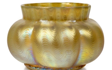 Loetz (Austrian), an iridescent Phaenomen Candia lobed glass bowl, c.1898, PG 6893, ground out pontil engraved Loetz Austria, The pale body decorated with undulating gold threads and banding, 13.3 cm high, 20.5 cm wide, Property from a private...