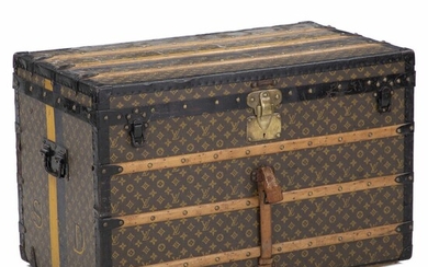 SOLD. Louis Vuitton: A Monogram Canvas trunk on wheels with wooden mouldings and brass mountings. One large tray inside. Ca. 1930. H. 90 cm. W. 59 cm. D. 52 cm. – Bruun Rasmussen Auctioneers of Fine Art