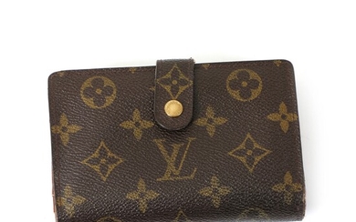 NOT SOLD. Louis Vuitton: A wallet made of brown monogram canvas with gold toned hardware,...