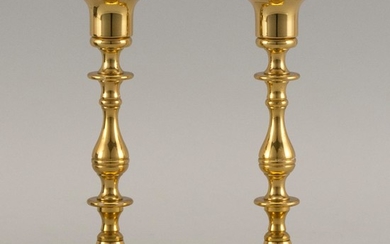 PAIR OF BRASS CANDLESTICKS With balustroid stems and circular molded feet. Heights 6.75".
