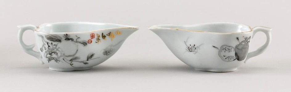 PAIR OF CHINESE PORCELAIN WINE CUPS In pear shape, with grisaille decoration of pomegranates and gilt highlights. Seal mark at spout...