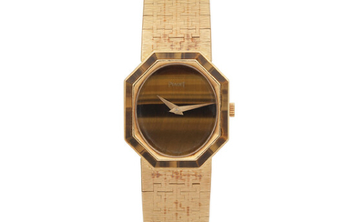 Piaget. A lady's 18K gold manual wind bracelet watch with tigers eye dial and bezel Ref 9341 A6, Circa 1980