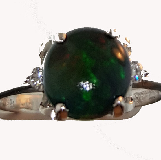Ring in white gold 750°/°°° with a night opal cabochon of approx. 2 ct. with two diamonds, Finger size 52, Gross weight: 2,89g